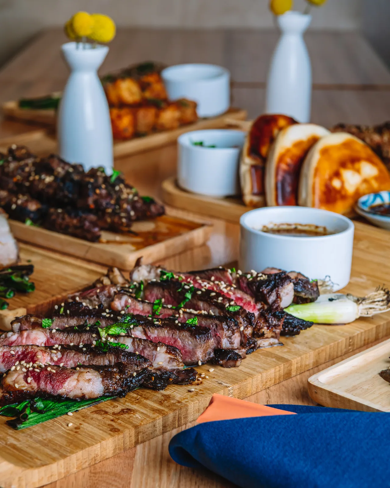 Grilled skewers topped with herbs on a wooden serving board