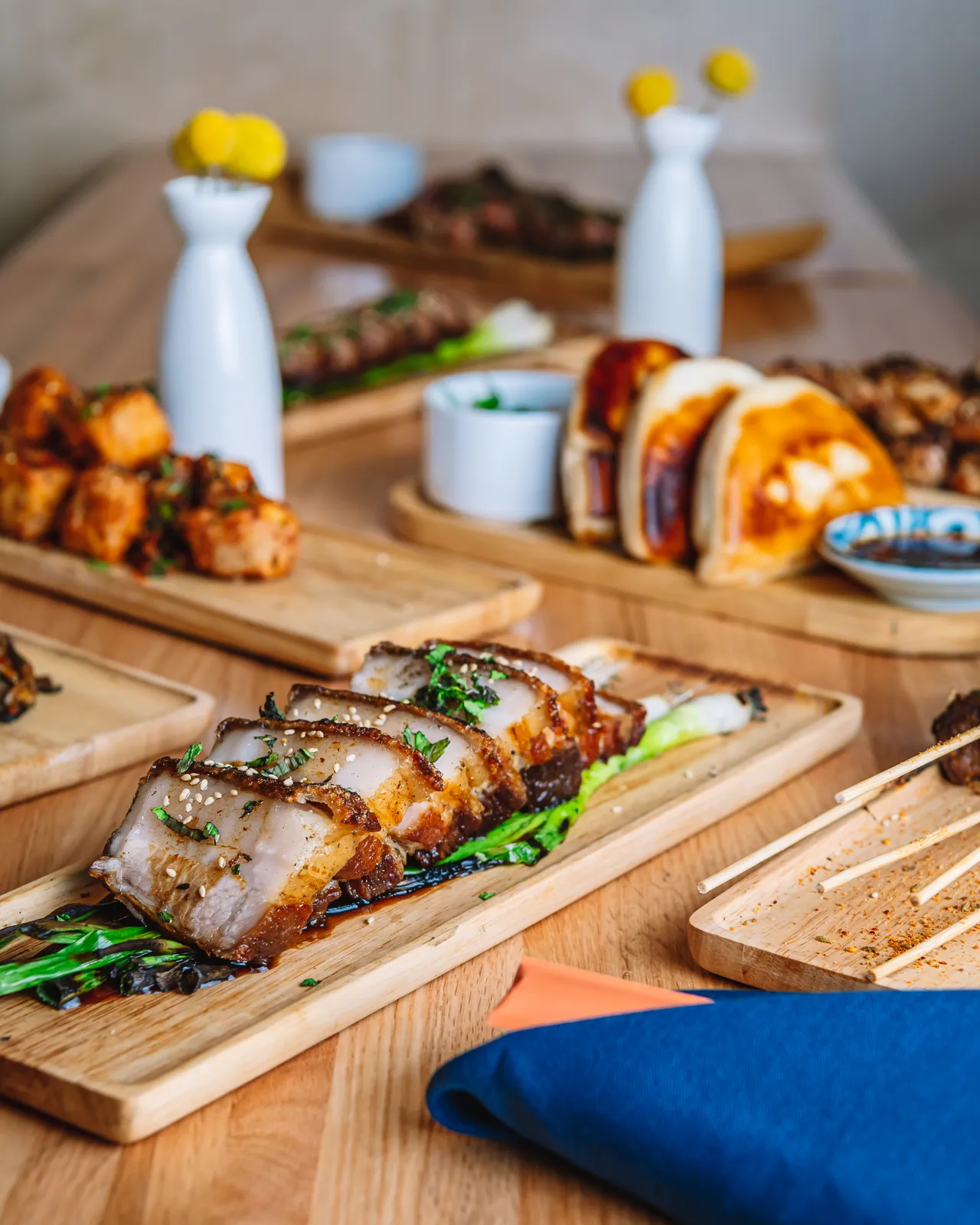 Grilled skewers and garnishes arranged across a table