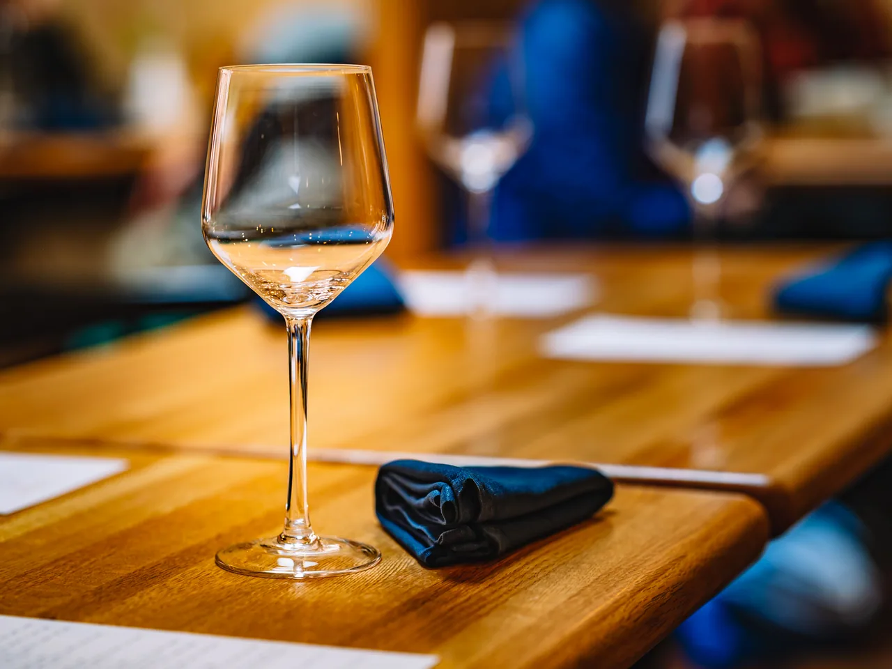 Empty wine glass on a set dining table