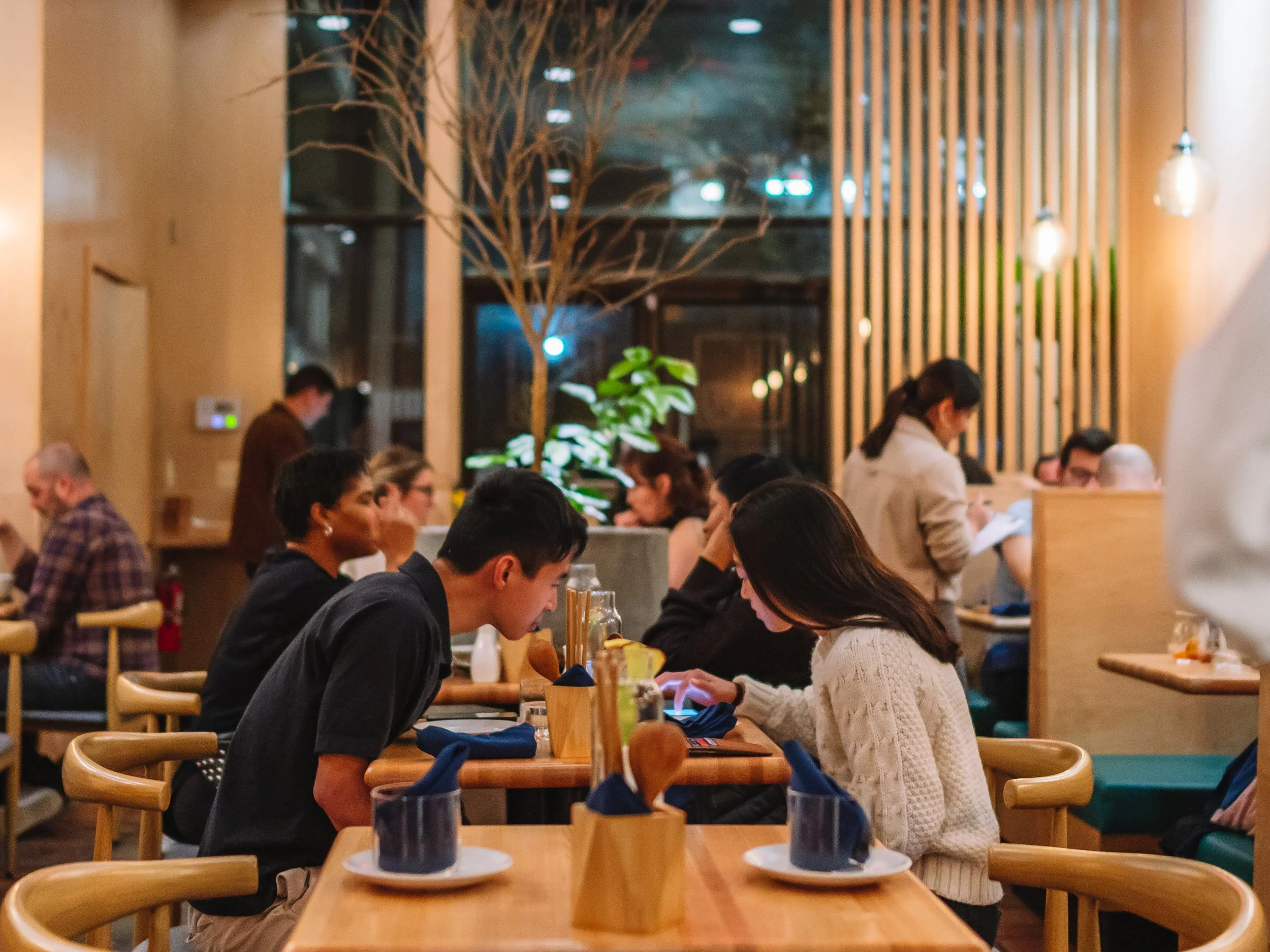 Guests sharing an evening in Yunnan By Potomac’s warmly lit dining room